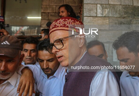 Jammu and Kashmir National Conference (JKNC) party leader Omar Abdullah (center) speaks with the media after a meeting at JKNC headquarters...