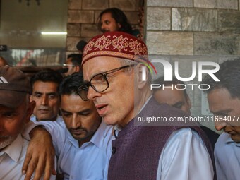 Jammu and Kashmir National Conference (JKNC) party leader Omar Abdullah (center) speaks with the media after a meeting at JKNC headquarters...