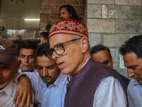 Jammu and Kashmir National Conference (JKNC) party leader Omar Abdullah (center) speaks with the media after a meeting at JKNC headquarters...