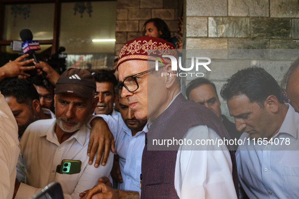 Jammu and Kashmir National Conference (JKNC) party leader Omar Abdullah (center) speaks with the media after a meeting at JKNC headquarters...