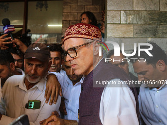 Jammu and Kashmir National Conference (JKNC) party leader Omar Abdullah (center) speaks with the media after a meeting at JKNC headquarters...