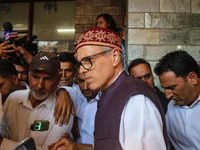 Jammu and Kashmir National Conference (JKNC) party leader Omar Abdullah (center) speaks with the media after a meeting at JKNC headquarters...