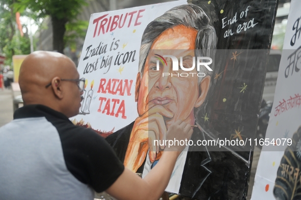 A teacher at Gurukul Art School paints a mural of Ratan Tata as a tribute in Mumbai, India, on October 10, 2024. Ratan Tata is the businessm...