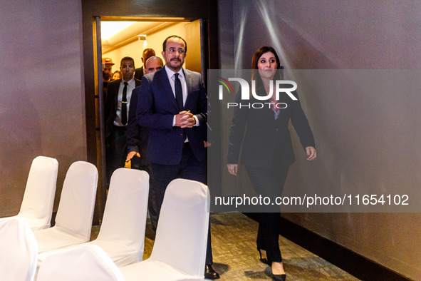 President of Cyprus Nikos Christodoulides and Deputy Minister of Shipping Marina Hadjimanolis enter the room in Limassol, Cyprus, on October...