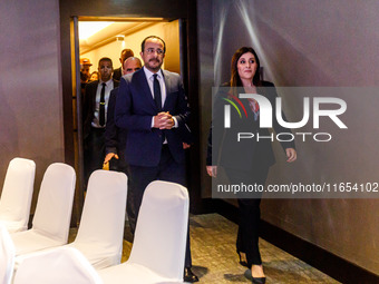 President of Cyprus Nikos Christodoulides and Deputy Minister of Shipping Marina Hadjimanolis enter the room in Limassol, Cyprus, on October...