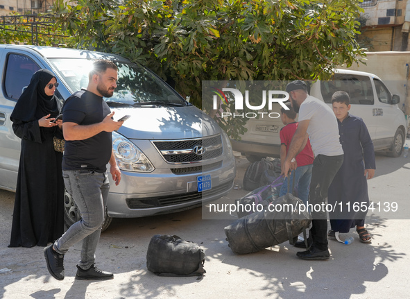 Syrian refugees return to their homeland through the Aoun Al-Dadat crossing in northern Manbij after traveling from Lebanon to opposition-he...