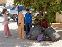 Syrian refugees return to their homeland through the Aoun Al-Dadat crossing in northern Manbij after traveling from Lebanon to opposition-he...