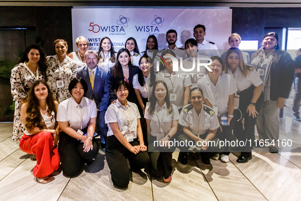 IMO Secretary-General Arsenio Dominguez and Deputy Minister of Shipping Marina Hadjimanolis stand among participants of the conference in Li...