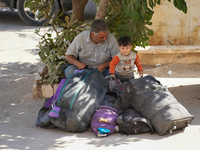 Syrian refugees return to their homeland through the Aoun Al-Dadat crossing in northern Manbij after traveling from Lebanon to opposition-he...