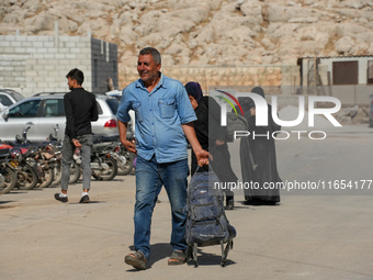 Syrian refugees return to their homeland through the Aoun Al-Dadat crossing in northern Manbij after traveling from Lebanon to opposition-he...