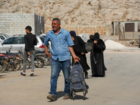 Syrian refugees return to their homeland through the Aoun Al-Dadat crossing in northern Manbij after traveling from Lebanon to opposition-he...