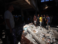 Palestinians inspect a school that the Israeli occupation army attacks in Deir al-Balah, Gaza, on October 10, 2024. The Israeli army attacks...