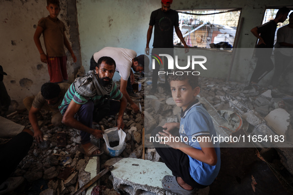 Palestinians inspect a school that the Israeli occupation army attacks in Deir al-Balah, Gaza, on October 10, 2024. The Israeli army attacks...