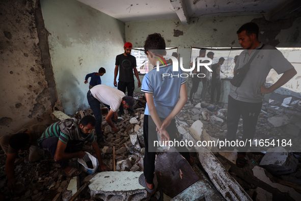 Palestinians inspect a school that the Israeli occupation army attacks in Deir al-Balah, Gaza, on October 10, 2024. The Israeli army attacks...