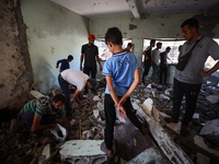 Palestinians inspect a school that the Israeli occupation army attacks in Deir al-Balah, Gaza, on October 10, 2024. The Israeli army attacks...