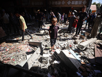 Palestinians inspect a school that the Israeli occupation army attacks in Deir al-Balah, Gaza, on October 10, 2024. The Israeli army attacks...