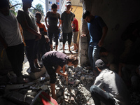 Palestinians inspect a school that the Israeli occupation army attacks in Deir al-Balah, Gaza, on October 10, 2024. The Israeli army attacks...