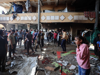 Palestinians inspect a school that the Israeli occupation army attacks in Deir al-Balah, Gaza, on October 10, 2024. The Israeli army attacks...