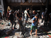 Palestinians inspect a school that the Israeli occupation army attacks in Deir al-Balah, Gaza, on October 10, 2024. The Israeli army attacks...