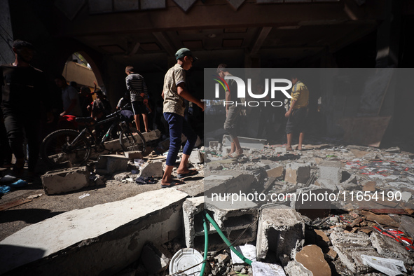 Palestinians inspect a school that the Israeli occupation army attacks in Deir al-Balah, Gaza, on October 10, 2024. The Israeli army attacks...