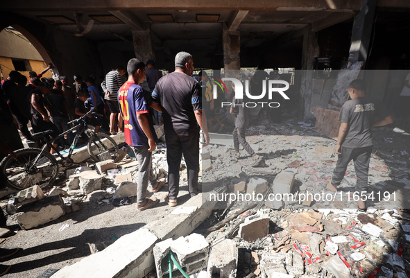 Palestinians inspect a school that the Israeli occupation army attacks in Deir al-Balah, Gaza, on October 10, 2024. The Israeli army attacks...