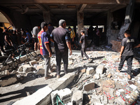 Palestinians inspect a school that the Israeli occupation army attacks in Deir al-Balah, Gaza, on October 10, 2024. The Israeli army attacks...