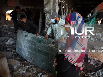 Palestinians inspect a school that the Israeli occupation army attacks in Deir al-Balah, Gaza, on October 10, 2024. The Israeli army attacks...