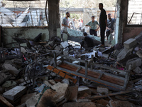 Palestinians inspect a school that the Israeli occupation army attacks in Deir al-Balah, Gaza, on October 10, 2024. The Israeli army attacks...