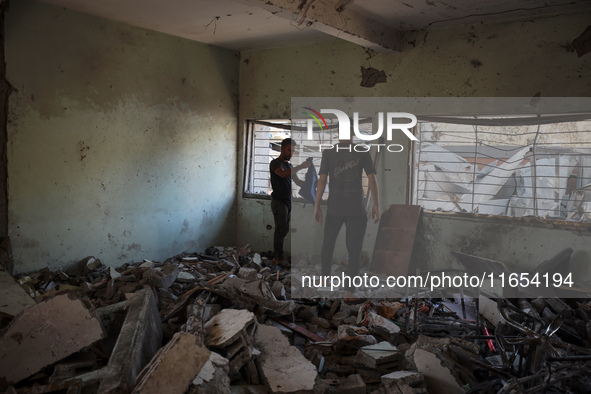 Palestinians inspect a school that the Israeli occupation army attacks in Deir al-Balah, Gaza, on October 10, 2024. The Israeli army attacks...