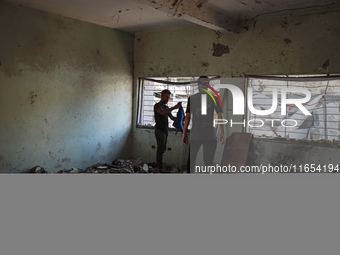 Palestinians inspect a school that the Israeli occupation army attacks in Deir al-Balah, Gaza, on October 10, 2024. The Israeli army attacks...