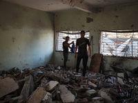 Palestinians inspect a school that the Israeli occupation army attacks in Deir al-Balah, Gaza, on October 10, 2024. The Israeli army attacks...