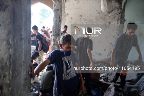 Palestinians inspect a school that the Israeli occupation army attacks in Deir al-Balah, Gaza, on October 10, 2024. The Israeli army attacks...