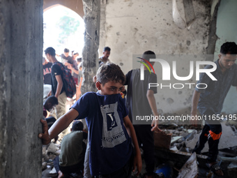 Palestinians inspect a school that the Israeli occupation army attacks in Deir al-Balah, Gaza, on October 10, 2024. The Israeli army attacks...