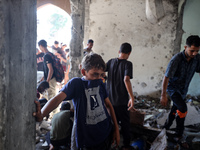 Palestinians inspect a school that the Israeli occupation army attacks in Deir al-Balah, Gaza, on October 10, 2024. The Israeli army attacks...