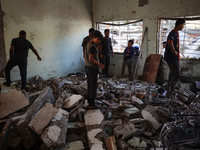 Palestinians inspect a school that the Israeli occupation army attacks in Deir al-Balah, Gaza, on October 10, 2024. The Israeli army attacks...