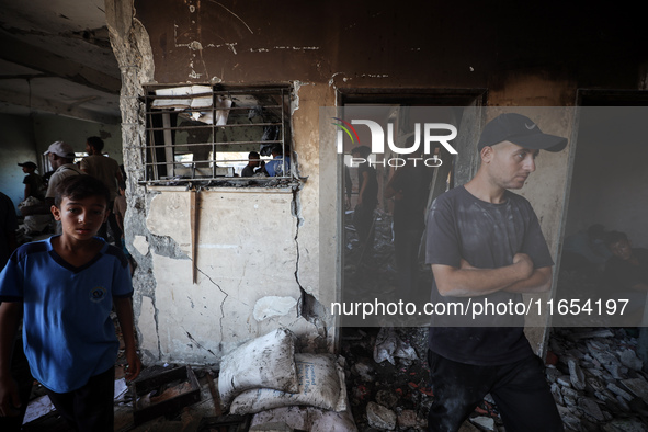 Palestinians inspect a school that the Israeli occupation army attacks in Deir al-Balah, Gaza, on October 10, 2024. The Israeli army attacks...