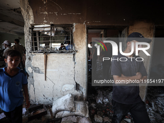 Palestinians inspect a school that the Israeli occupation army attacks in Deir al-Balah, Gaza, on October 10, 2024. The Israeli army attacks...