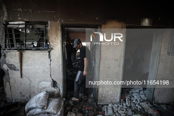 Palestinians inspect a school that the Israeli occupation army attacks in Deir al-Balah, Gaza, on October 10, 2024. The Israeli army attacks...