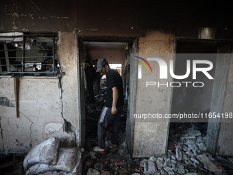 Palestinians inspect a school that the Israeli occupation army attacks in Deir al-Balah, Gaza, on October 10, 2024. The Israeli army attacks...