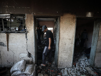 Palestinians inspect a school that the Israeli occupation army attacks in Deir al-Balah, Gaza, on October 10, 2024. The Israeli army attacks...