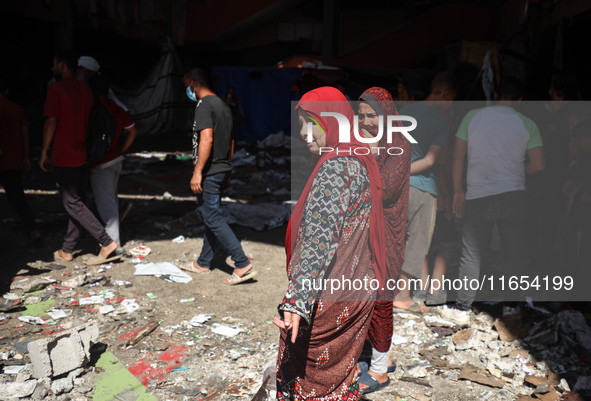 Palestinians inspect a school that the Israeli occupation army attacks in Deir al-Balah, Gaza, on October 10, 2024. The Israeli army attacks...