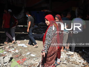 Palestinians inspect a school that the Israeli occupation army attacks in Deir al-Balah, Gaza, on October 10, 2024. The Israeli army attacks...