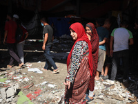 Palestinians inspect a school that the Israeli occupation army attacks in Deir al-Balah, Gaza, on October 10, 2024. The Israeli army attacks...