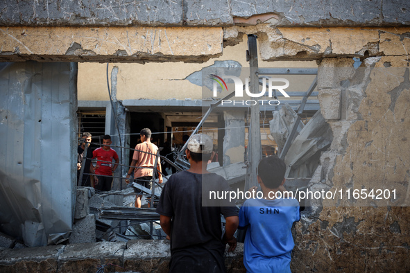 Palestinians inspect a school that the Israeli occupation army attacks in Deir al-Balah, Gaza, on October 10, 2024. The Israeli army attacks...