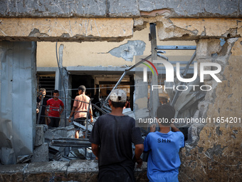 Palestinians inspect a school that the Israeli occupation army attacks in Deir al-Balah, Gaza, on October 10, 2024. The Israeli army attacks...