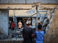 Palestinians inspect a school that the Israeli occupation army attacks in Deir al-Balah, Gaza, on October 10, 2024. The Israeli army attacks...