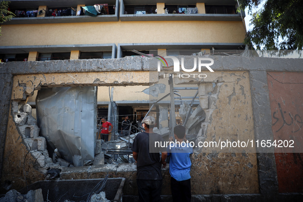 Palestinians inspect a school that the Israeli occupation army attacks in Deir al-Balah, Gaza, on October 10, 2024. The Israeli army attacks...