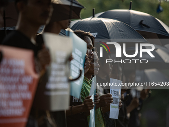 Human rights activists participate in the 835th Aksi Kamisan, or Thursday's Protest, in front of the Presidential Palace in Jakarta, Indones...