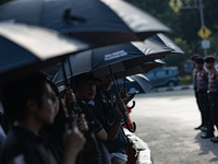 Human rights activists participate in the 835th Aksi Kamisan, or Thursday's Protest, in front of the Presidential Palace in Jakarta, Indones...