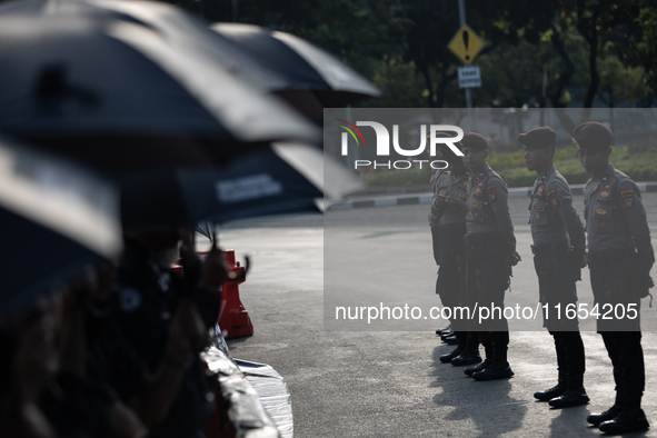 Police stand guard during the 835th Aksi Kamisan, or Thursday's Protest, in front of the Presidential Palace in Jakarta, Indonesia, on Octob...